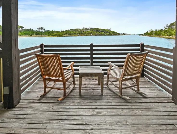 Two rocking chairs facing the water